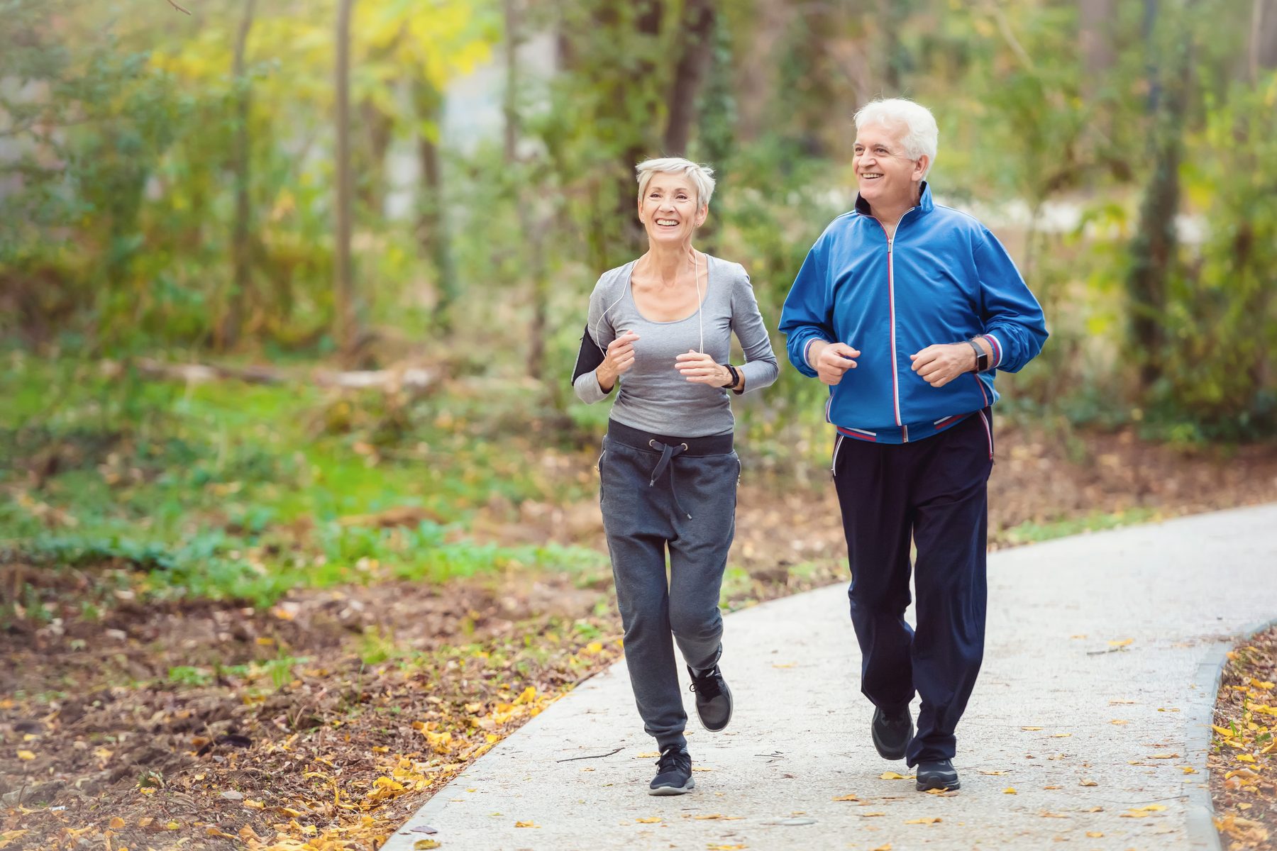 An active older couple jogging together outdoors -- the everyday vitality functional medicine aims to restore.